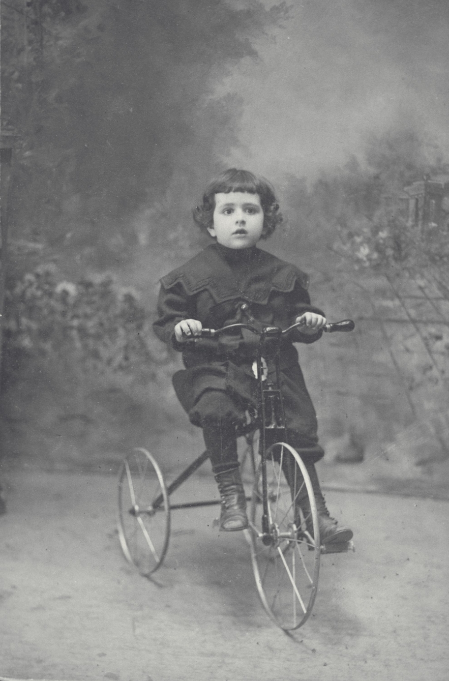 Portrait of a young boy on a tricycle