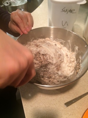 Carefully folding the dry ingredients with the "Schnee," or beaten egg whites