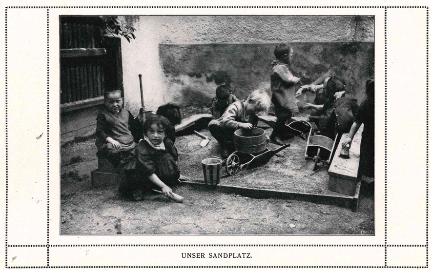 A kindergarten class playing in a sandbox